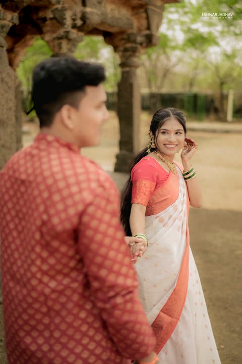 Bride smiling at the groom, seen over his shoulder